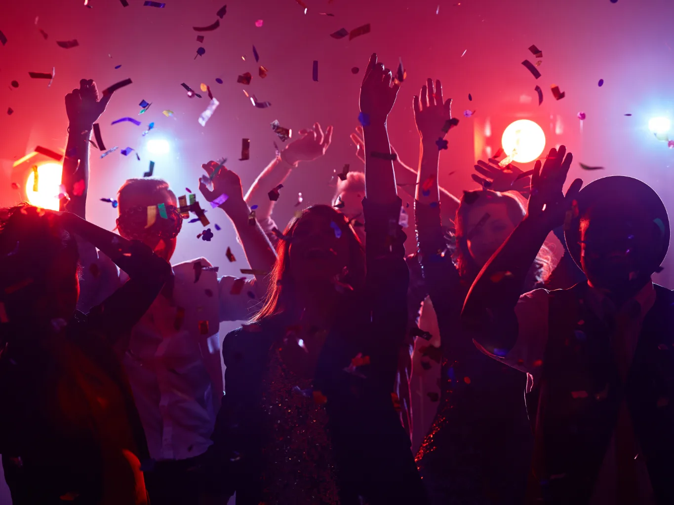 A dj working on a residential parties and special events job — mid-task, hands, tools and the work itself in sharp focus, the rest of the space softly out of focus